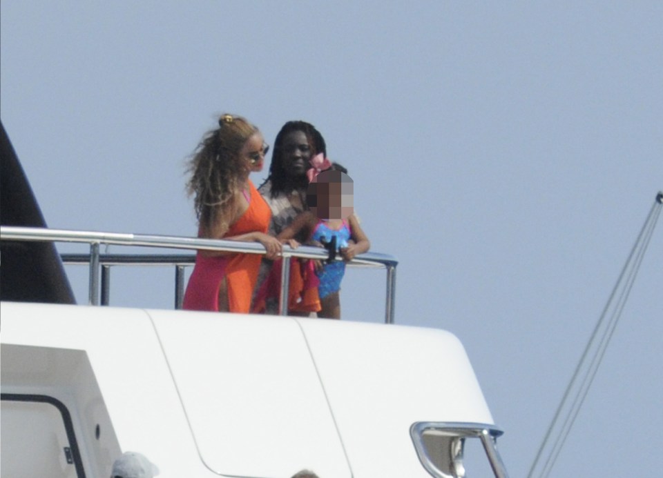 The singer soaks up some rays above-deck