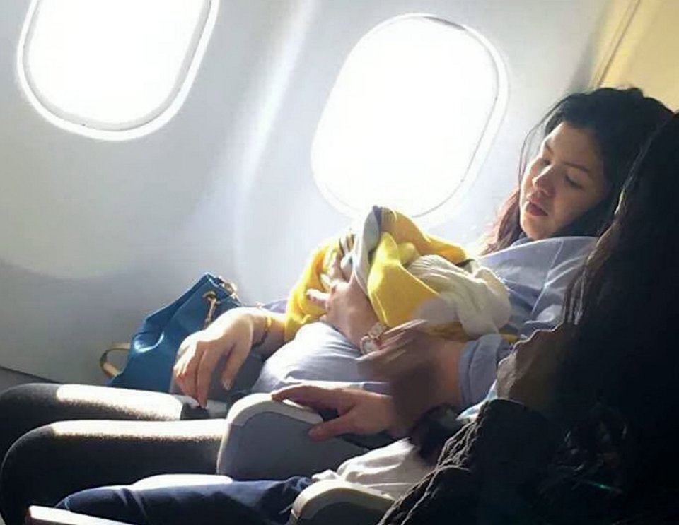 An incredible pictures shows the moment a woman cradles her newborn baby after giving birth on board a Cebu Pacific Air flight 
