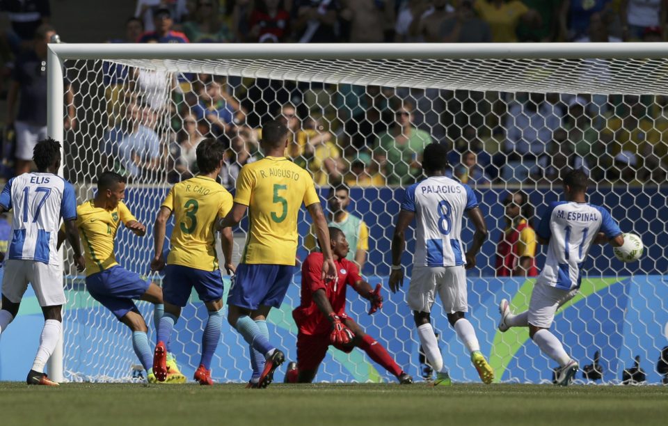 Marquinhos of Brazil (second from L) scores his team's fourth goal of the game past goalkeeper Luis Lopez