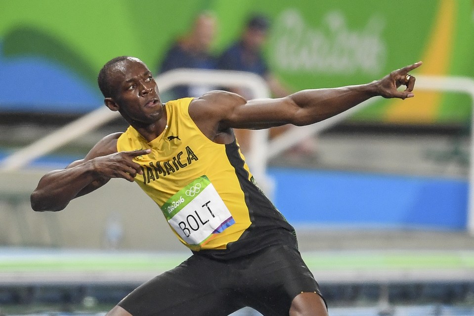 The Jamaican strikes his trademark pose in celebration of his 200m win