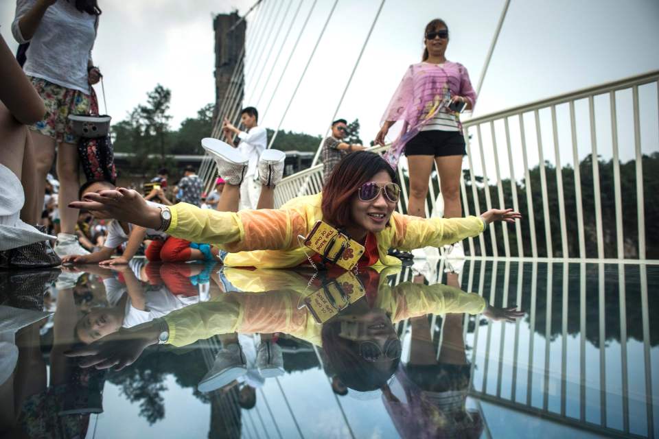 A visitor poses for a photograph on the