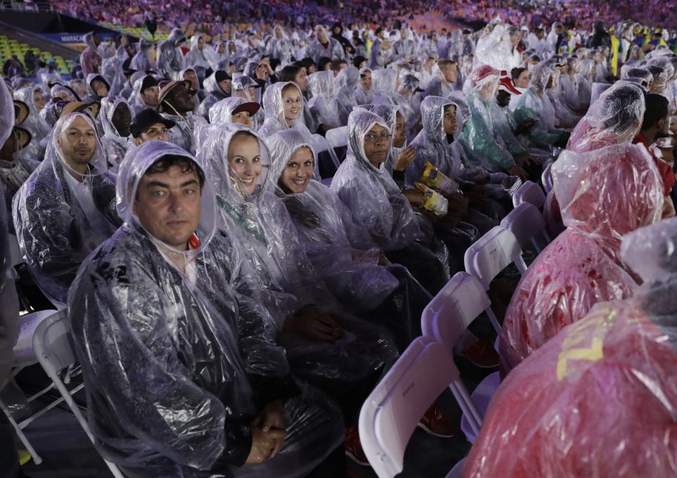 Some athletes looked soaked and fed up as they waited for the closing ceremony to finish in the Maracana Stadium