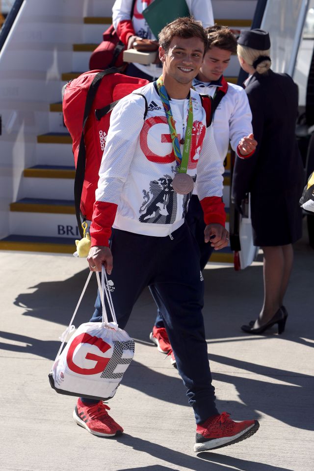 Tom Daley struts off the flight with his bronze medal from the diving 