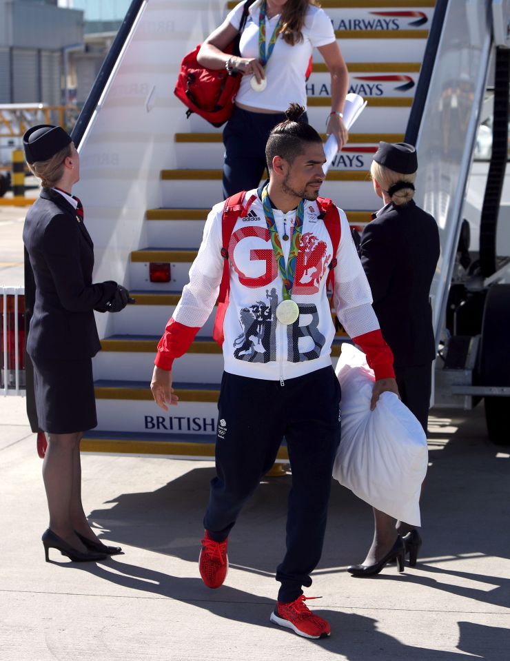 Louis Smith walks off the flight holding his pillow
