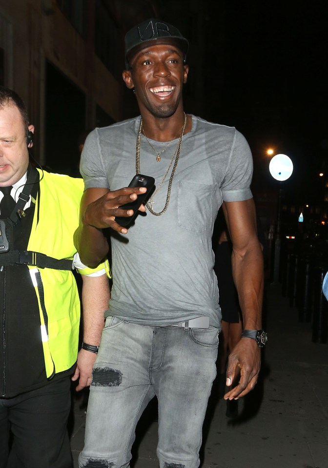 Usain Bolt is all smiles as he gets in the party spirit in London