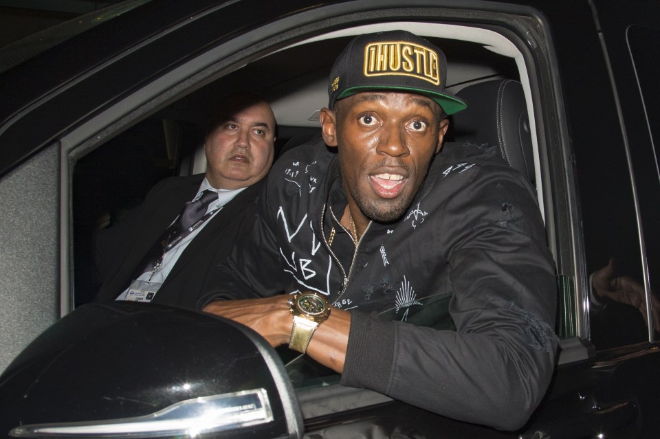 Usain Bolt shows off his personalised jacket and gold watch outside Project Nightclub