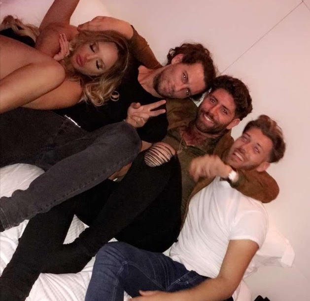 Charlotte and Ash pose for a picture amongst friends at the after-after-party in a London hotel