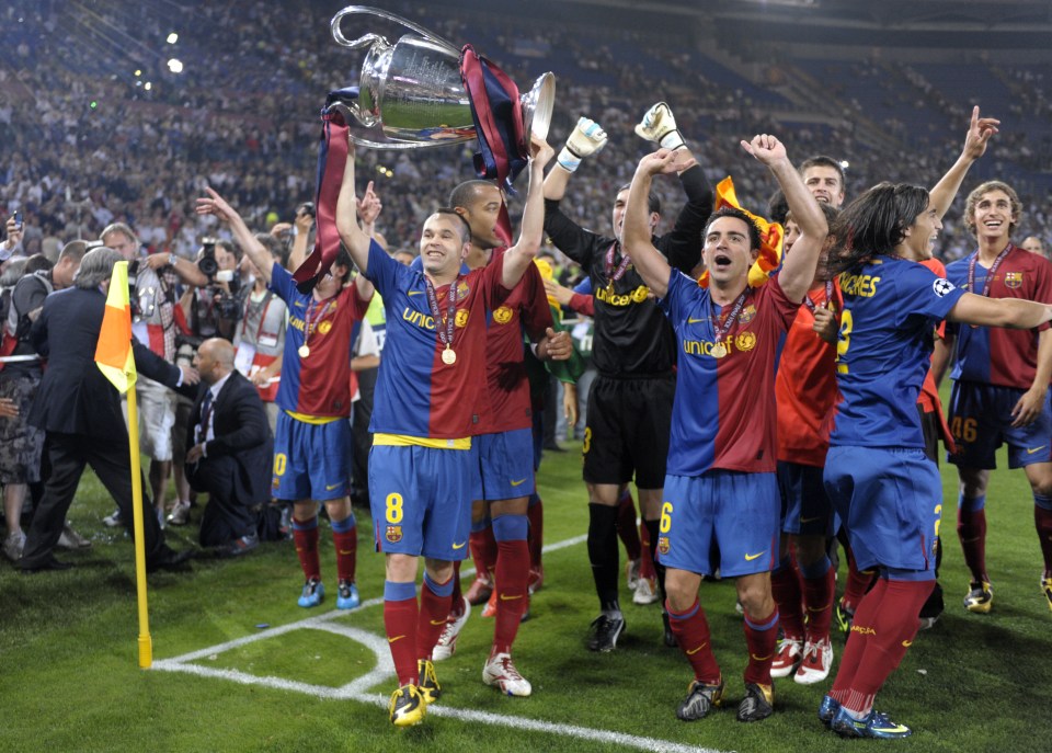 Barcelona?s midfielder Andres Iniesta holds the Champions League Cup as he celebrates with teammates after the trophy ceremony on May 27, 2009 at the Olympic Stadium in Rome. Barcelona defeated Manchester United 2-0 in the final of the UEFA football Champions League. AFP PHOTO / LLUIS GENE (Photo credit should read LLUIS GENE/AFP/Getty Images)