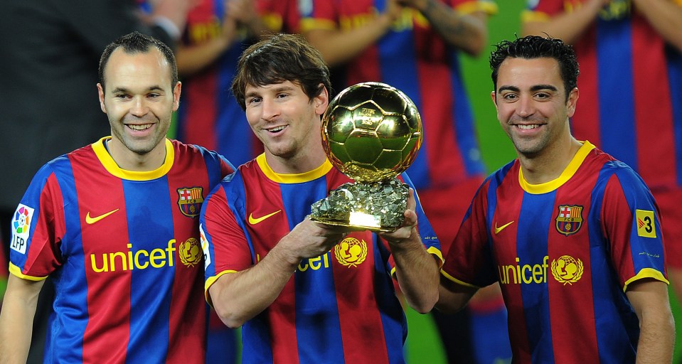 Barcelona's Argentinian forward Lionel Messi (C), flanked with Barcelona's midfielder Xavi Hernandez (R) and Barcelona's midfielder Andres Iniesta (L), poses with the 2010 Ballon d'Or trophy (Golden Ball) for the best European footballer of the year prior to the Copa del Rey (King's Cup) football match FC Barcelona vs Real Betis on January 12, 2011 at the Camp Nou stadium in Barcelona. AFP PHOTO/ LLUIS GENE (Photo credit should read LLUIS GENE/AFP/Getty Images)
