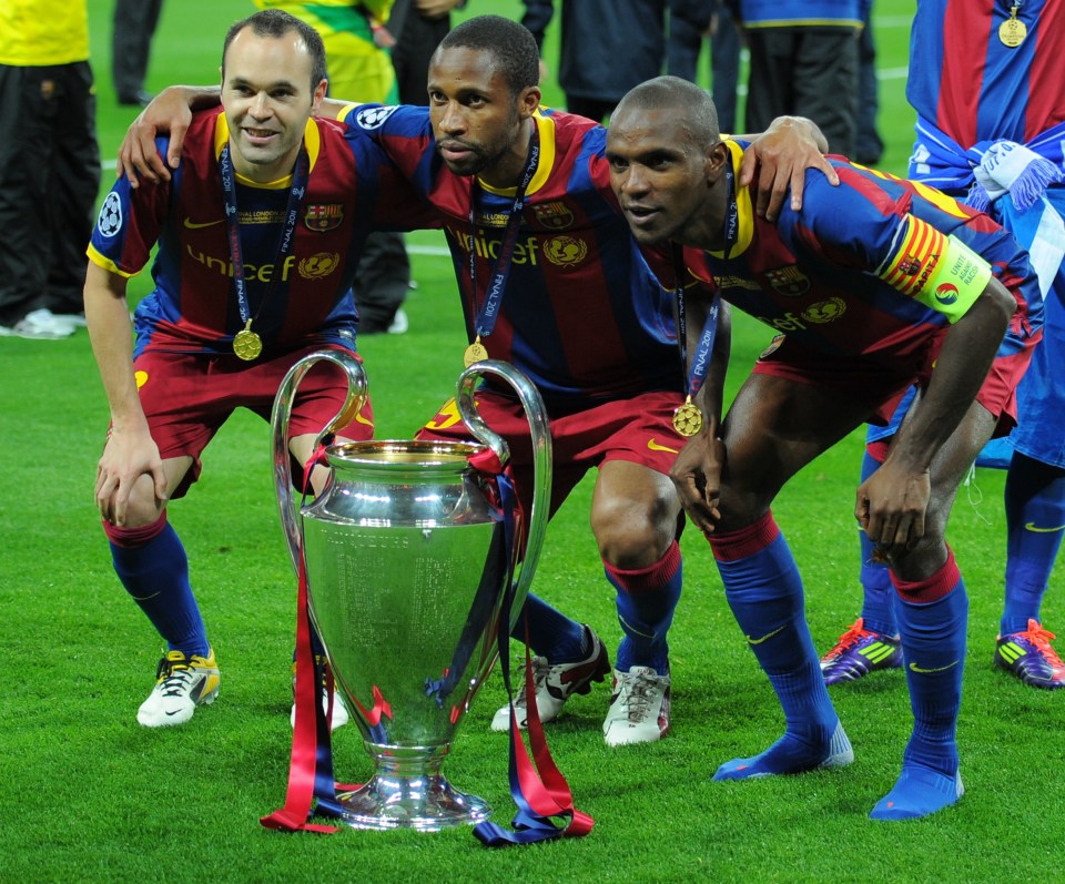 (LtoR) Barcelona's Spanish midfielder Andres Iniesta, Barcelona's Malian midfielder Seydou Keita and Barcelona's French defender Eric Abidal pose next to the trophy at the end of the UEFA Champions League final football match FC Barcelona vs. Manchester United, on May 28, 2011 at Wembley stadium in London.Barcelona won 3 to 1. AFP PHOTO / LLUIS GENE (Photo credit should read LLUIS GENE/AFP/Getty Images)