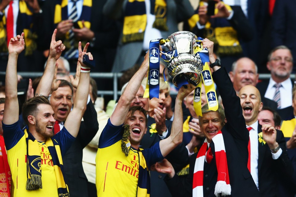 LONDON, ENGLAND - MAY 30: Nacho Monreal of Arsenal and Arsene Wenger manager of Arsenal lift the winners trophy following the FA Cup Final between Aston Villa and Arsenal at Wembley Stadium on May 30, 2015 in London, England. (Photo by Paul Gilham/Getty Images)