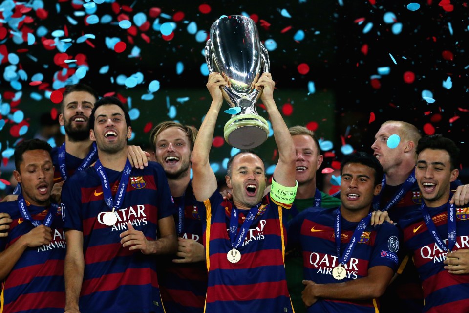 TBILISI, GEORGIA - AUGUST 11: Andres Iniesta of Barcelona lifts the UEFA Cup trophy as Barcelona celebrate victoy during the UEFA Super Cup between Barcelona and Sevilla FC at Dinamo Arena on August 11, 2015 in Tbilisi, Georgia. (Photo by Chris Brunskill/Getty Images)