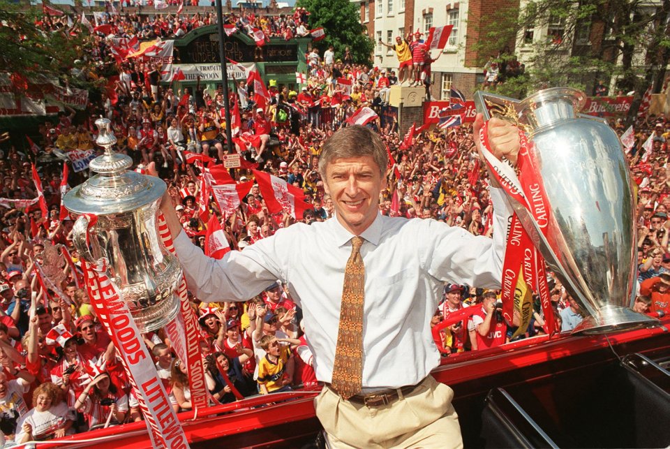 LON27:SPORT-SOCCER:LONDON,17MAY98 - Arsenal's French manager Arsene Wenger holds both the League and the FA Cup trophies at a victory parade in London May 17. Arsenal fans lined north London streets to cheer their team who defeated Newcastle United 2-0 at Wembley stadium yesterday. sr/POOL/Photo by John Stillwell REUTERS Used in The Times Premiership 98-99 Supplement (10.08.1998).