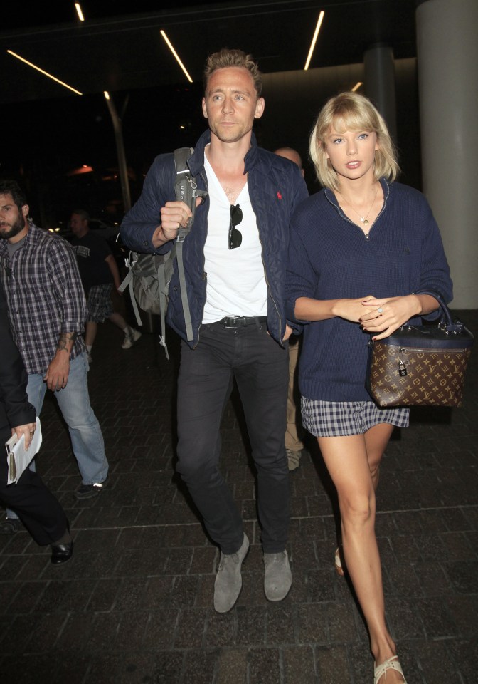 Taylor Swift & Tom Hiddleston continue their world tour as they fly out of Los Angeles surrounded by several bodyguards. The "1989" singer & "The Avengers" actor were seen side by side as they caught a flight out of LAX.