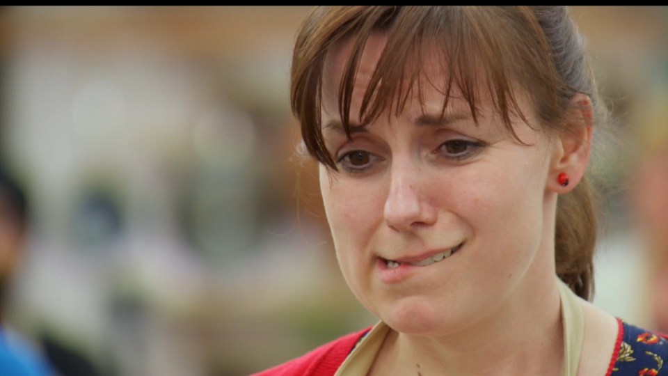 Contestant Kate looks concerned as the judges try her bake 