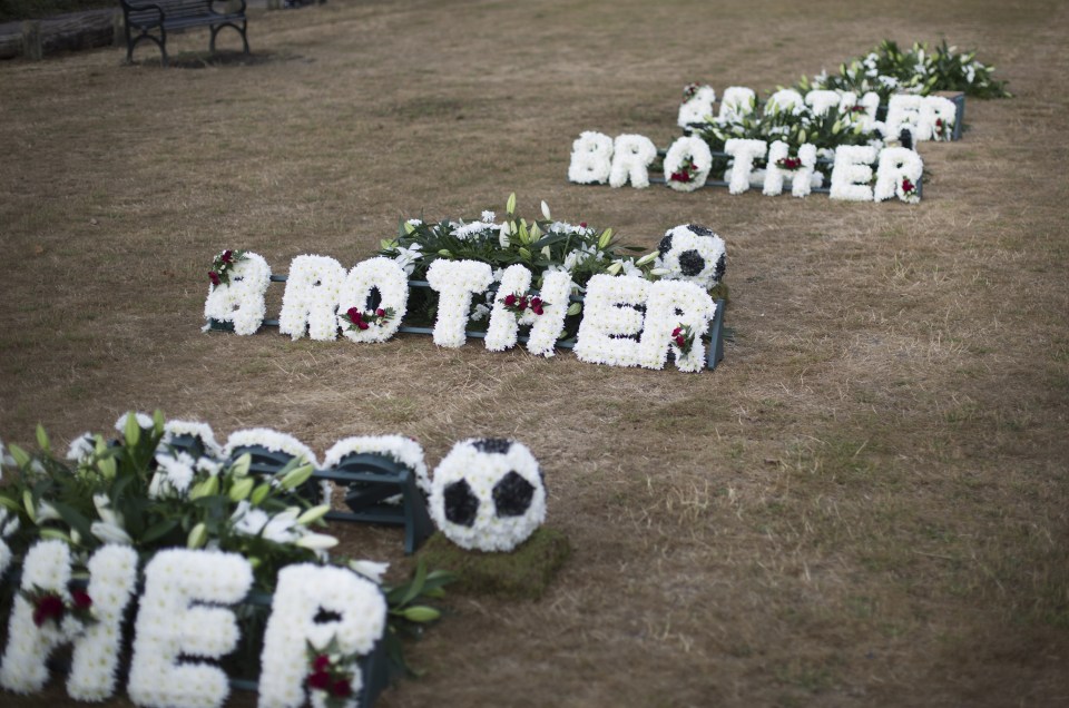 The funeral included flower wreathes being laid for the five young men