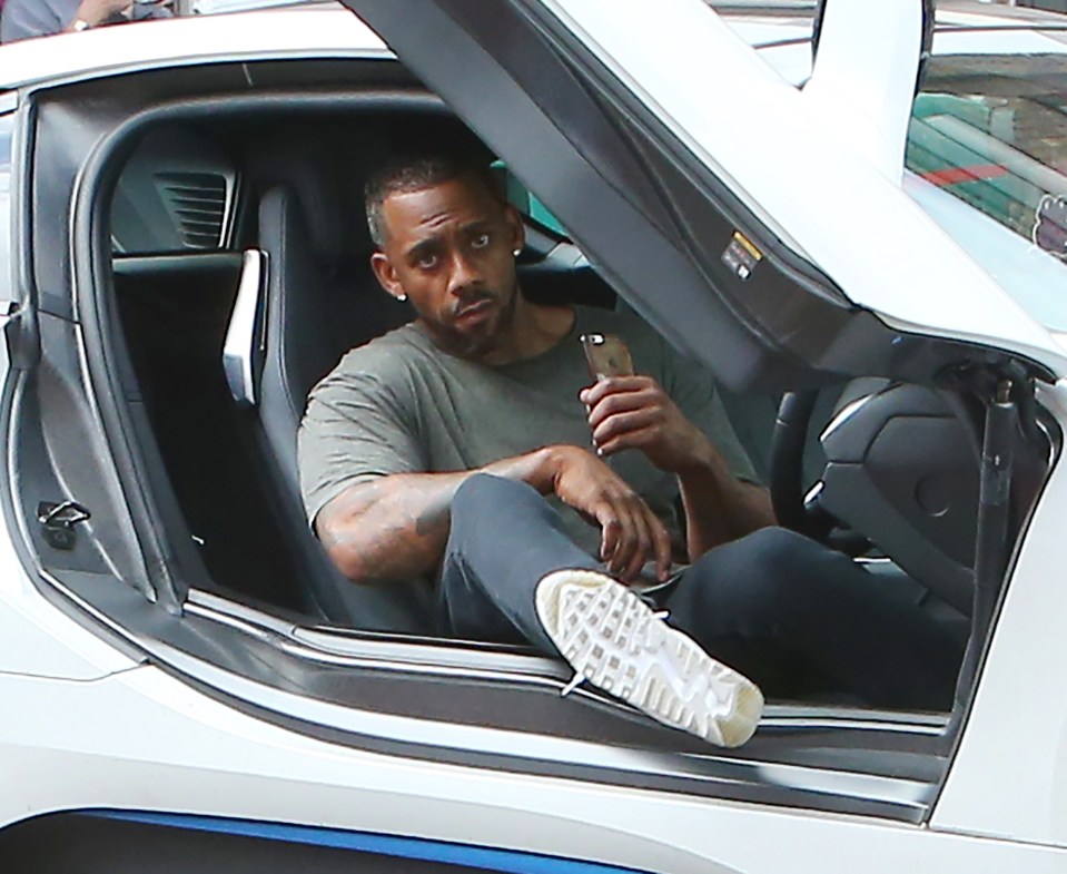 He was spotted climbing out of the low-slung luxury vehicle