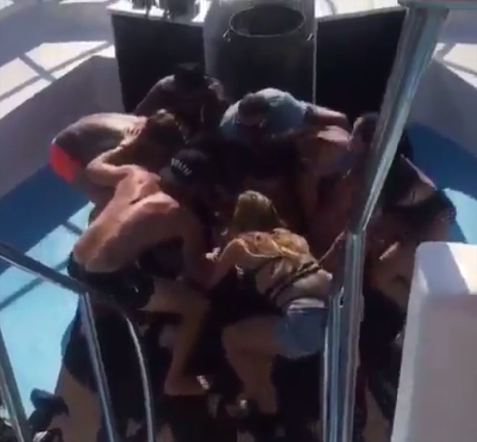 The group crouched down on boat a swish boat for a boogie