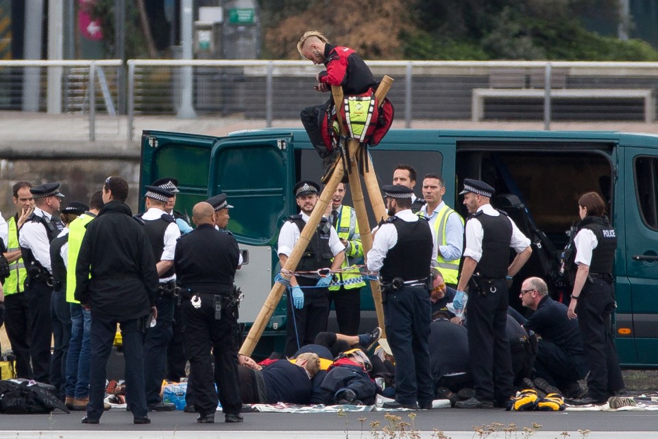 High hopes ... Black Lives Matter shut down London City Airport by chaining themselves together on the runway