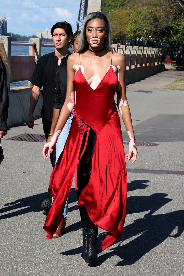 Winnie wore a low cut red dress to watch Kanye's latest Yeezy fashion show