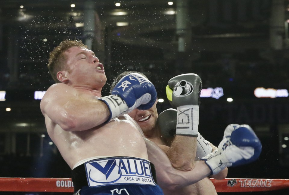 Canelo Alvarez, left, takes a shot from Liam Smith fight during the WBO Junior Middleweight championship boxing match at the stadium in Arlington, Texas, Saturday, Sept. 17, 2016. Alvarez won with a knock out in the ninth round. (AP Photo/LM Otero)