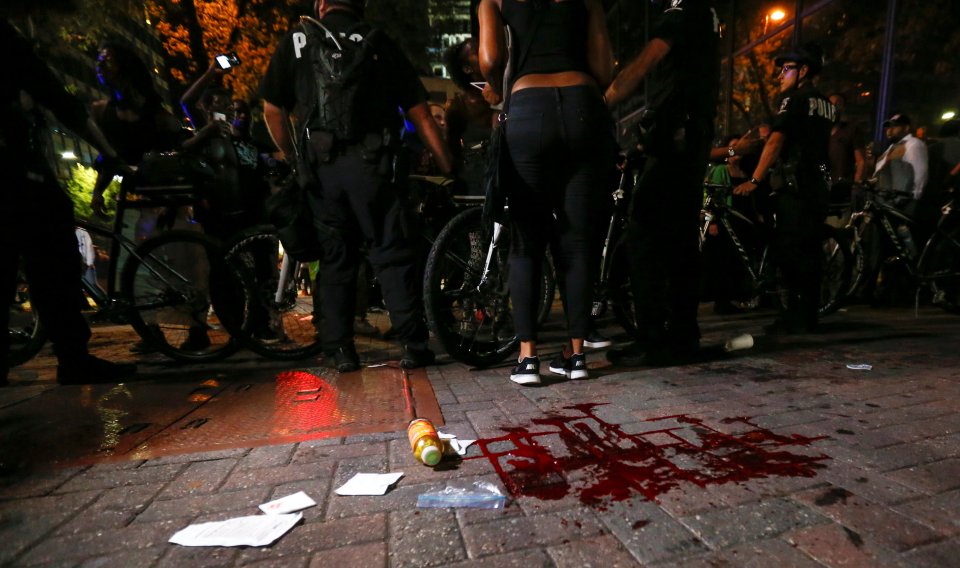 Blood covers the pavement where a person was shot in uptown Charlotte, NC during a protest of the police shooting of Keith Scott, in Charlotte