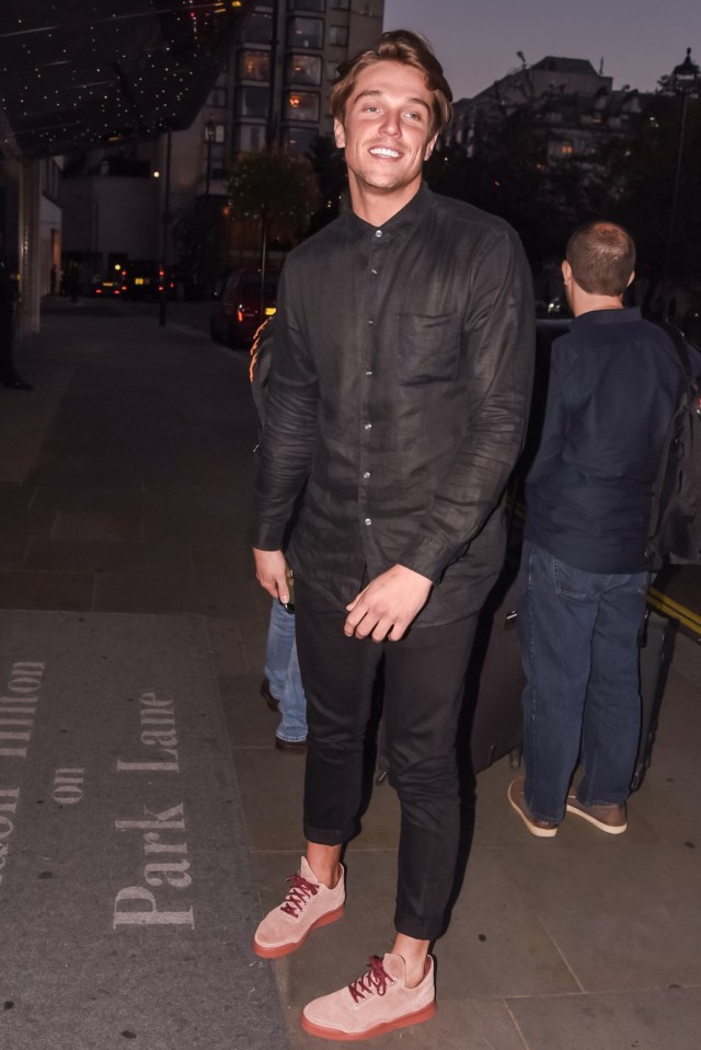 Lewis looked happy and tanned despite being without his girlfriend