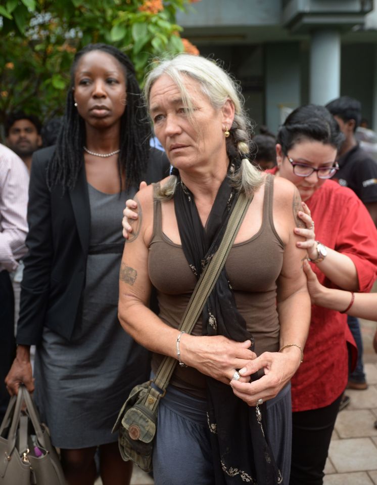 The grieving mother is comforted outside court