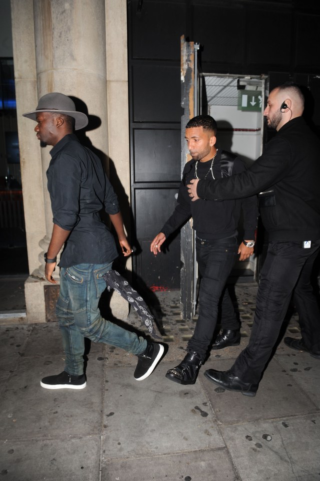 Everton's Aaron Lennon, dressed head to toe in black, was escorted out of the club