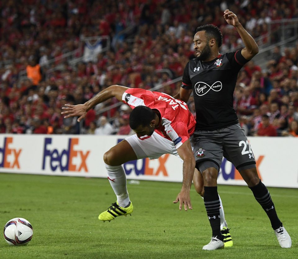 Southampton's Nathan Redmond tangles with Hapoel Be'ers-Sheva's Loai Taha