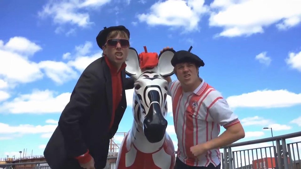The pair then travel around various famous signs around their city singing the ode to the club