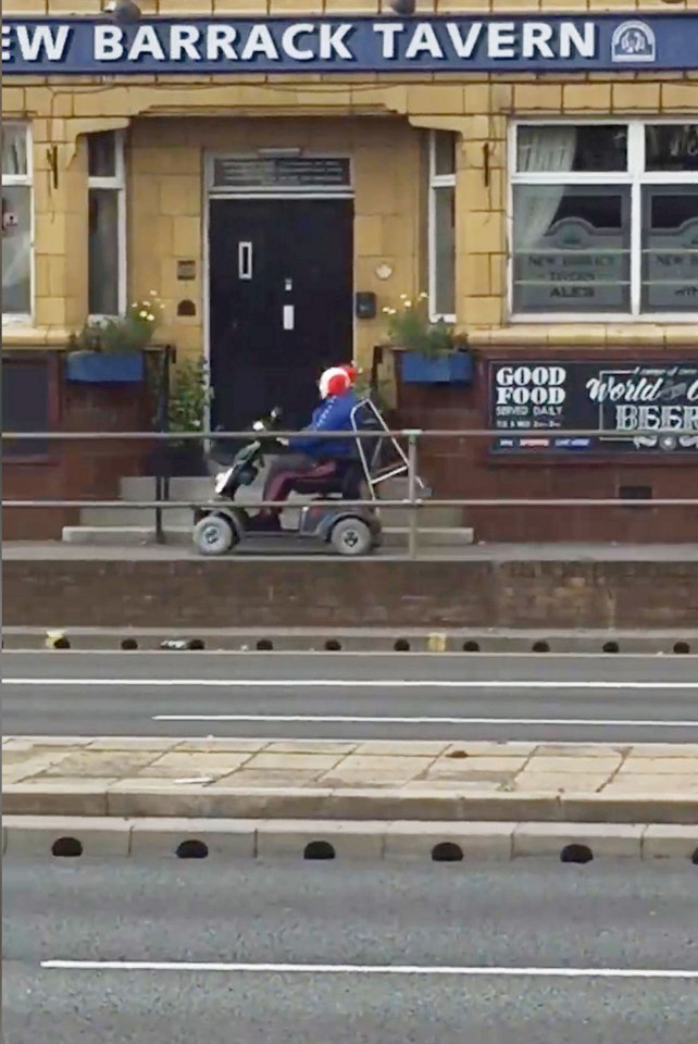 A clown on a mobility scooter heading south in the Hillsborough area of Sheffield