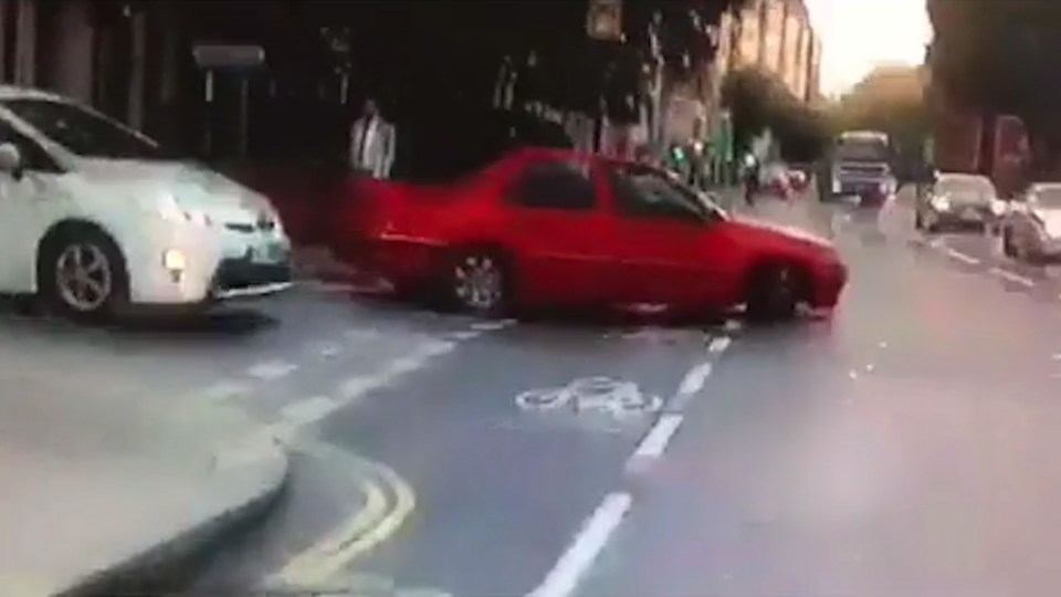 The red car can be seen to pull out from behind the white car, turning in front of Vine and leaving the journalist shocked