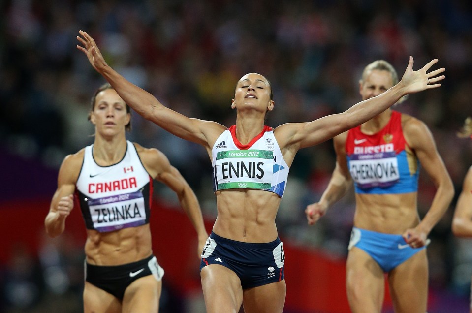 Jessica Ennis-Hill raises her arms aloft in celebration as 80,000 spectators roar her home to gold in London 2012