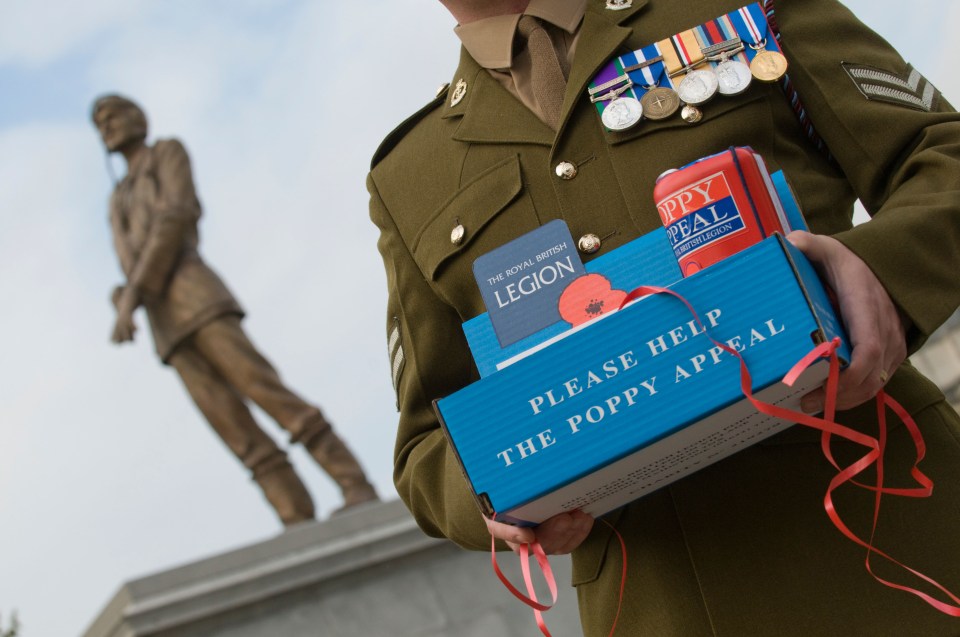 Remembrance Day. People gather in Trafalgar Square for the two minute silence and to place poppy petals in the fountains.. Image shot 2009. Exact date unknown.