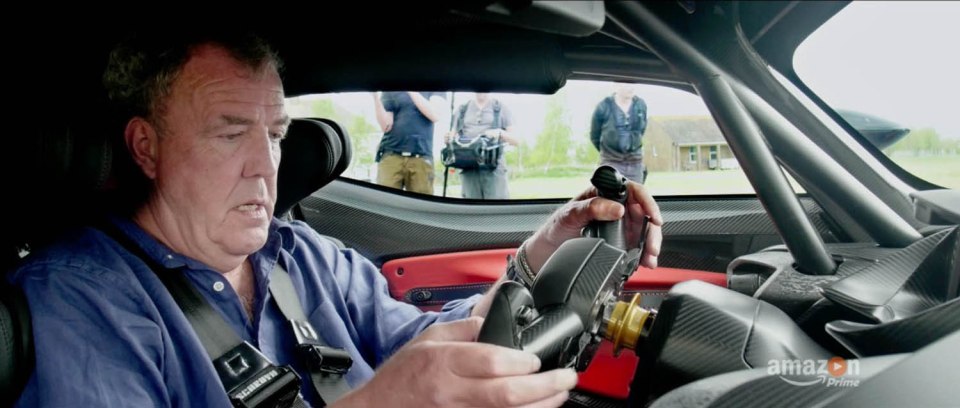 The host is baffled by the futuristic controls of a new supercar