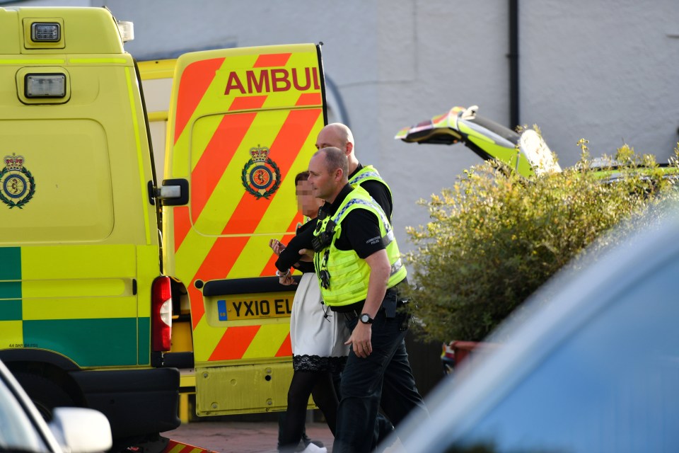 The woman was taken to a nearby ambulance to be checked over before being taken into custody