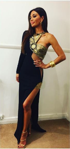 Nicole stunned in the black and gold dress