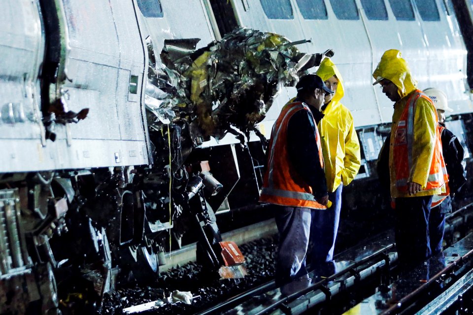 Emergency responders work near a train that sits derailed near the community of New Hyde Park on Long Island in New York