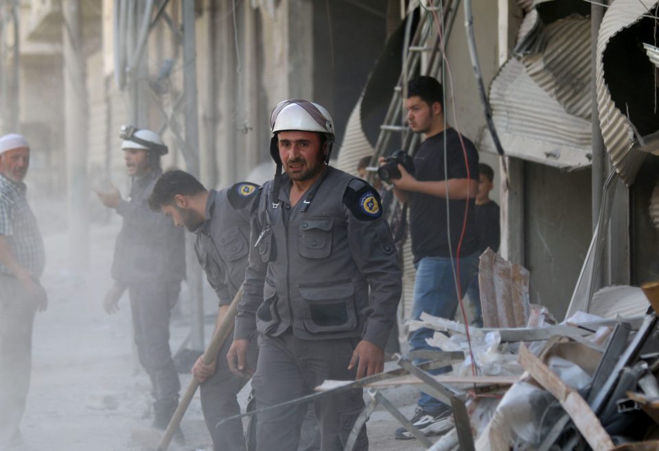 Civil defense members carry out search and rescue operations in Damascus