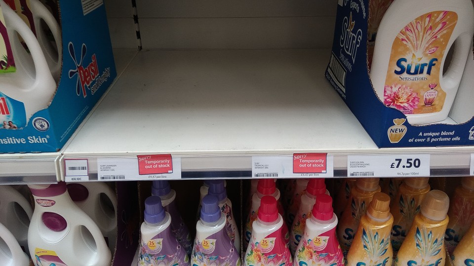 An empty shelf sits where the Surf washing liquid would be at the Tesco Extra store in Old Trafford, Manchester