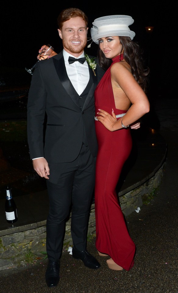 She posed with her hand on her mystery man's shoulder
