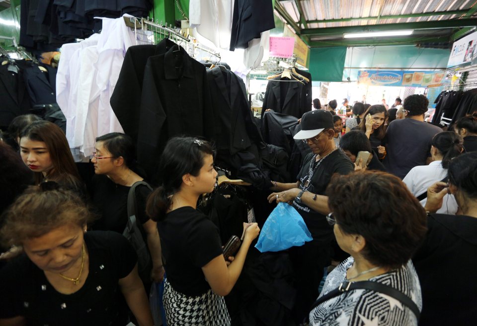 Thai people can be seen buying black shirts to properly mourn their late monarch