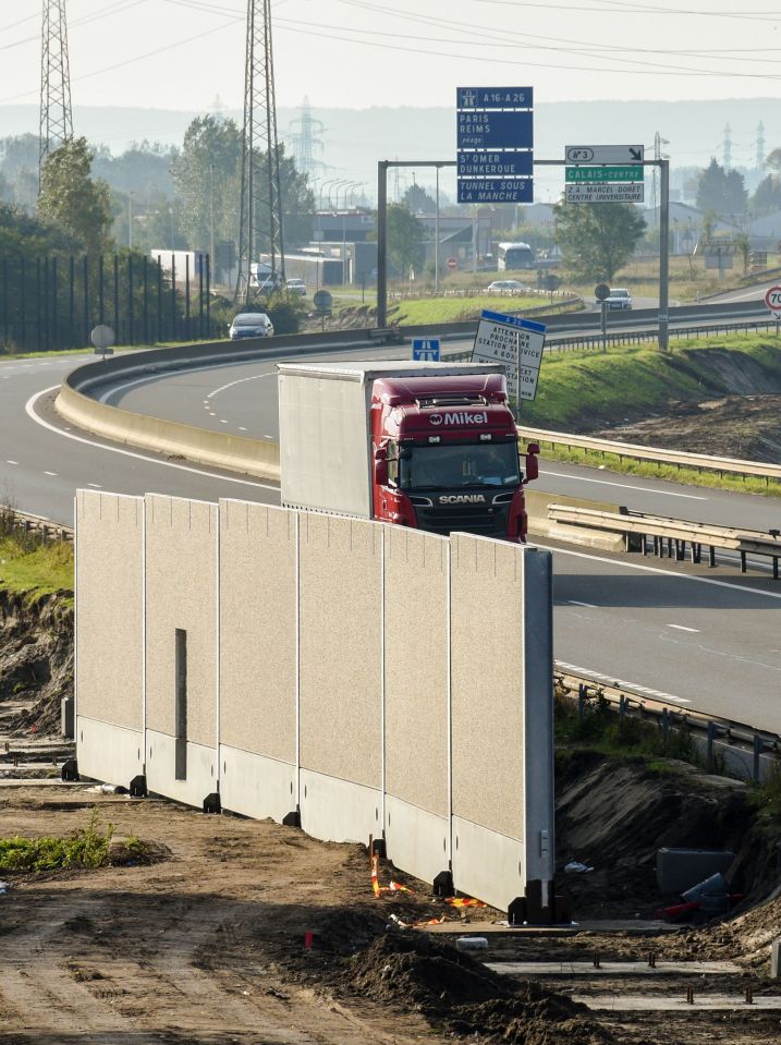 Trucks are being driven on a road along