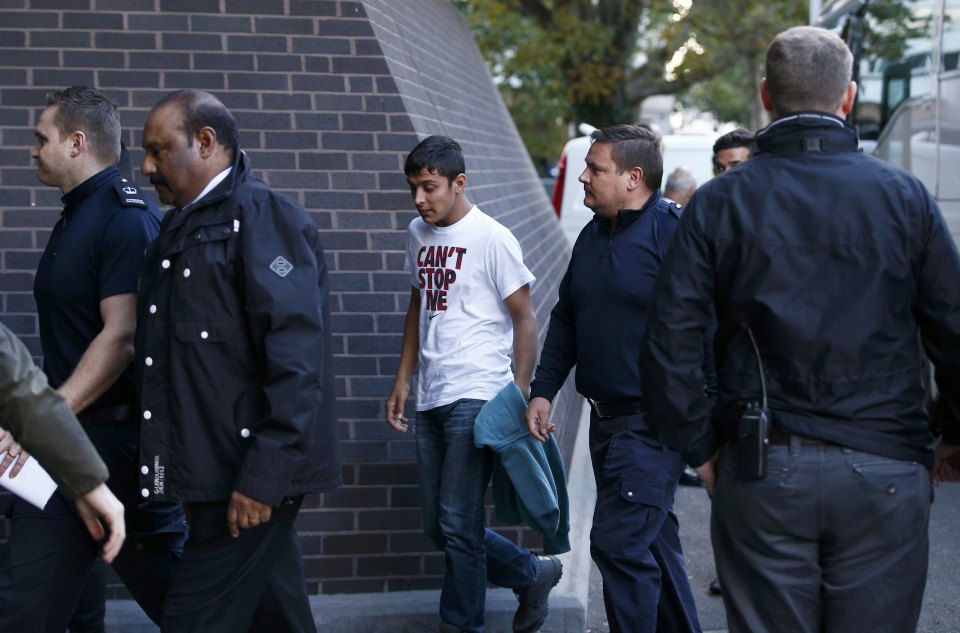 Uk Border Force staff escort the youths into the Home Office building in Croydon