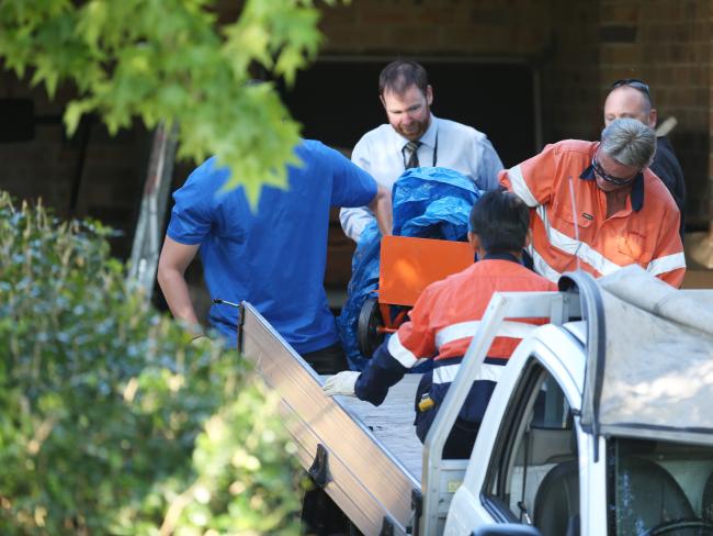 Gas safety experts are seen removing canisters from the property