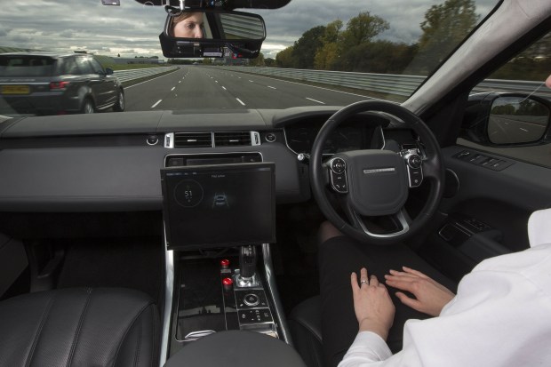 A research engineer demonstrates the car's ‘advanced highway assist’ function