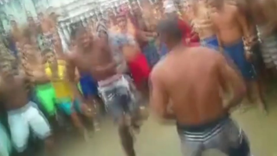 Two two inmates square up to each other before launching into full-scale brawl