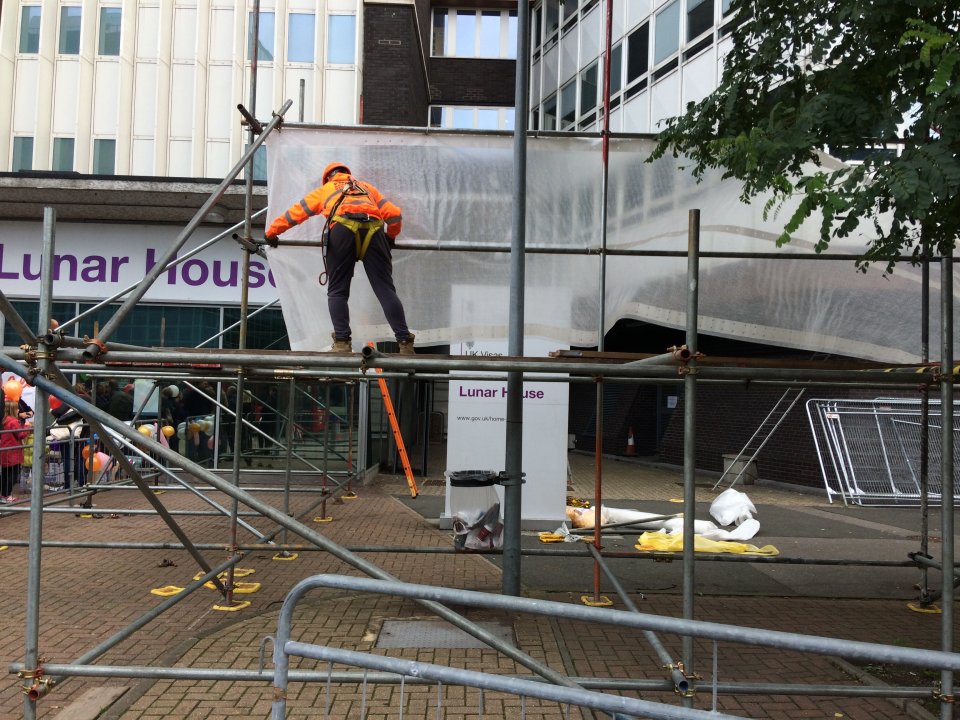 Construction workers put up 15ft high scaffolding