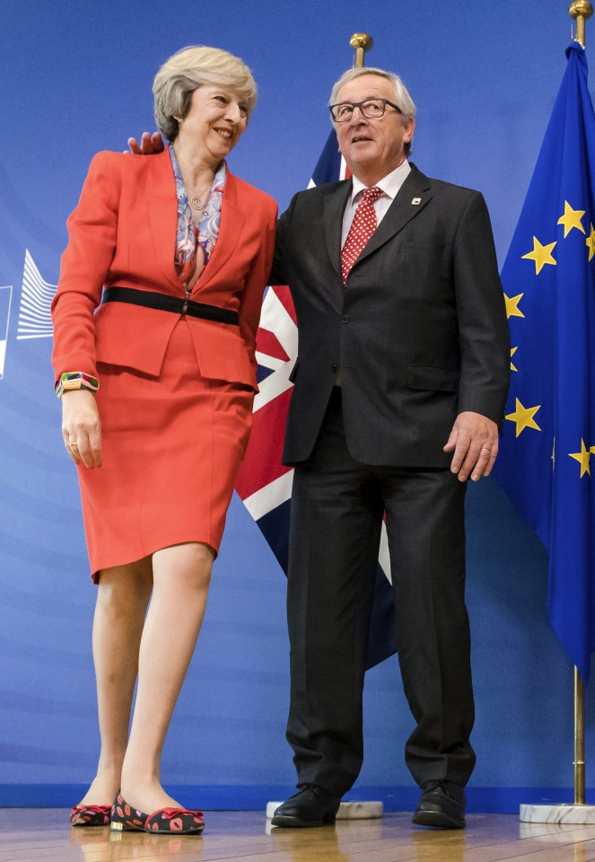 European Commission President Jean-Claude Juncker, right, welcomes British Prime Minister Theresa May upon her arrival at EU headquarters in Brussels on Friday